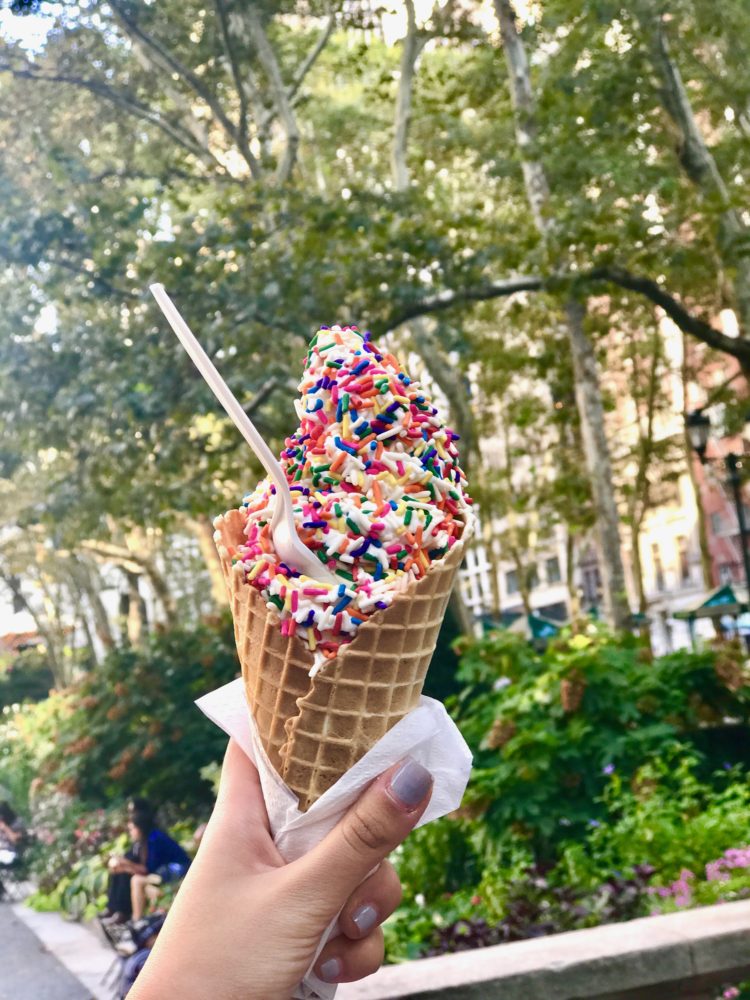 Classic soft serve ice cream topped with sprinkles in a Waffle Cone